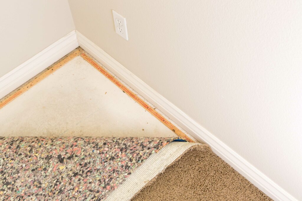 pulled back carpet of room