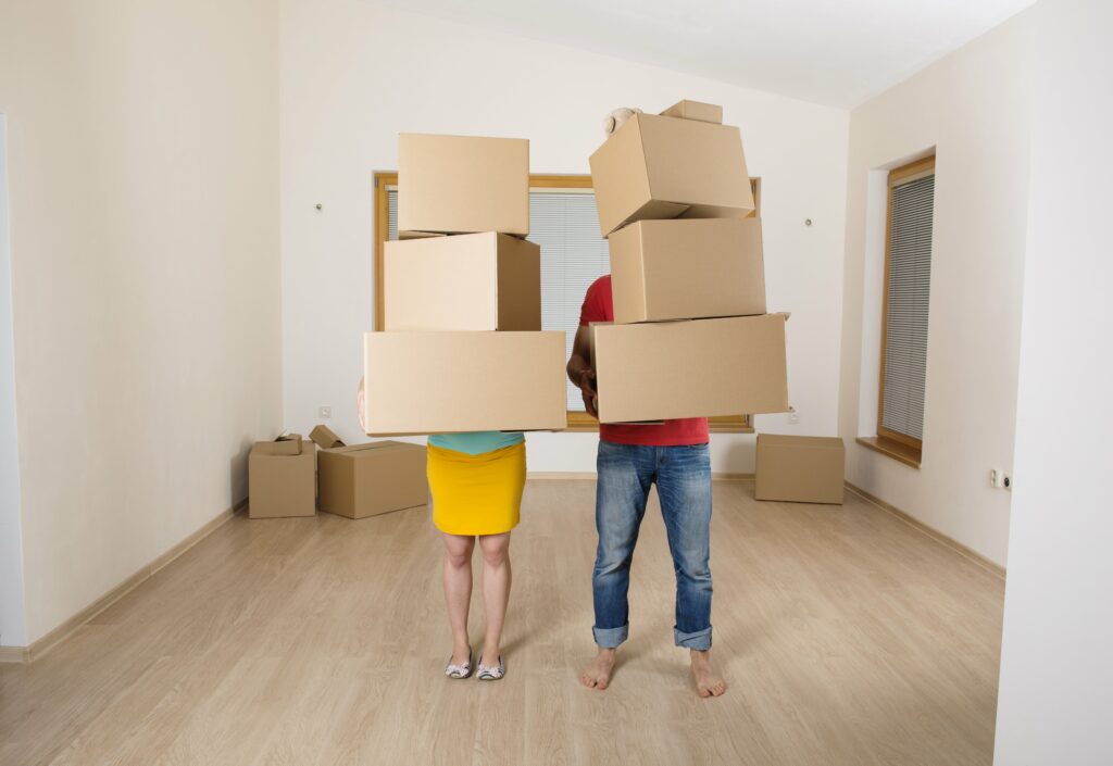couple moving boxes in home