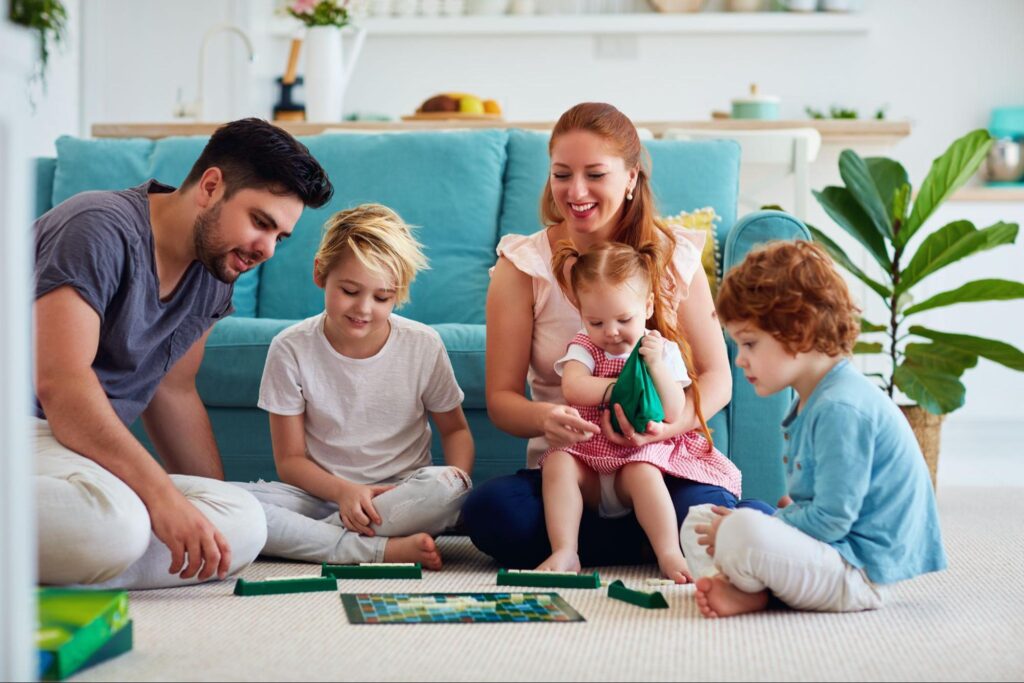 cheerful-family-having-fun-spending-time-together-by-playing-board-games-at-home