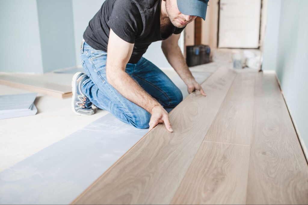 close-up-of-the-work-of-a-master-floating-flooring-installation-installing-laminate-on-the-floor-male-hands-during-work