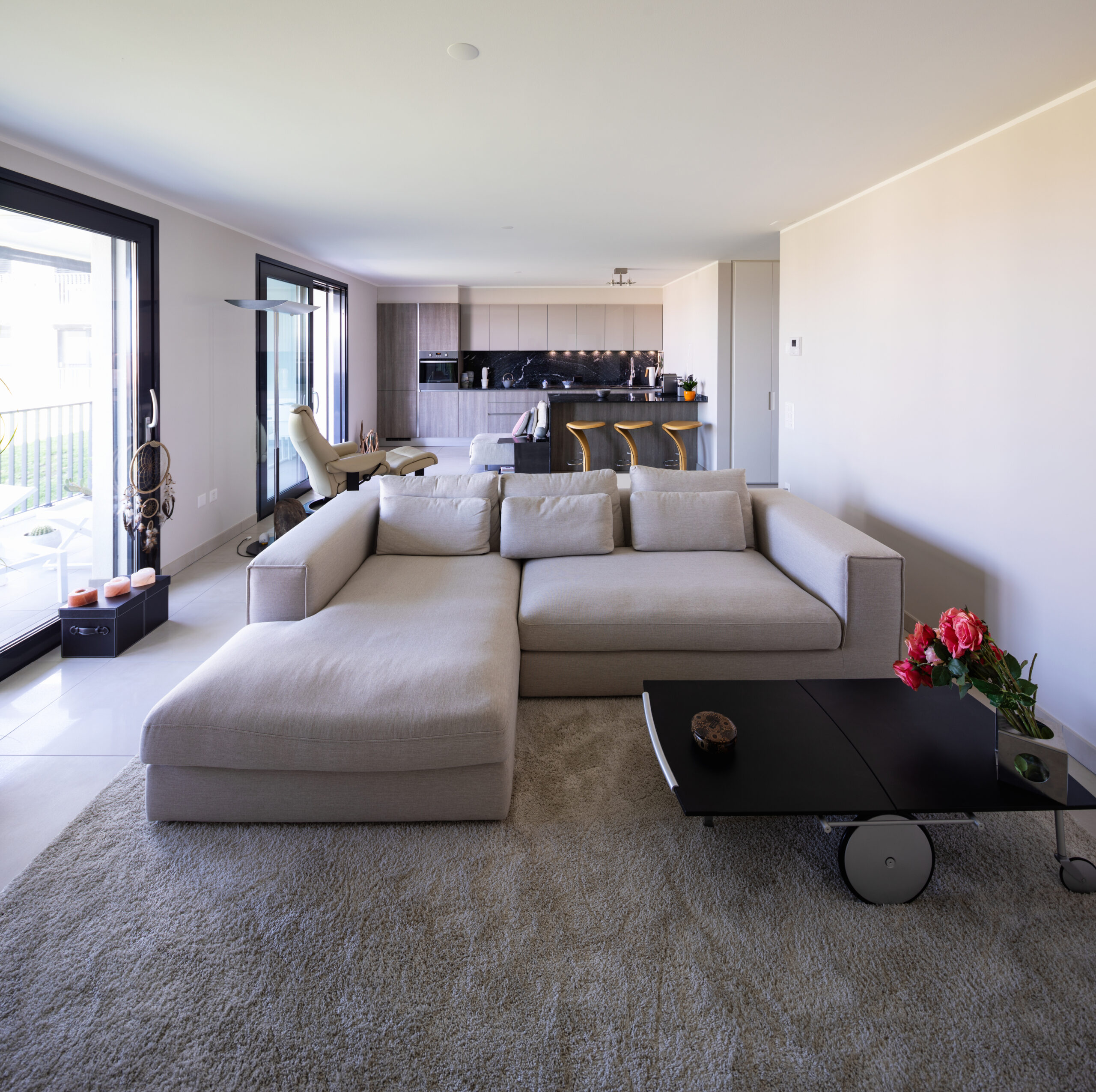 Carpet under tan couch and dark coffee table