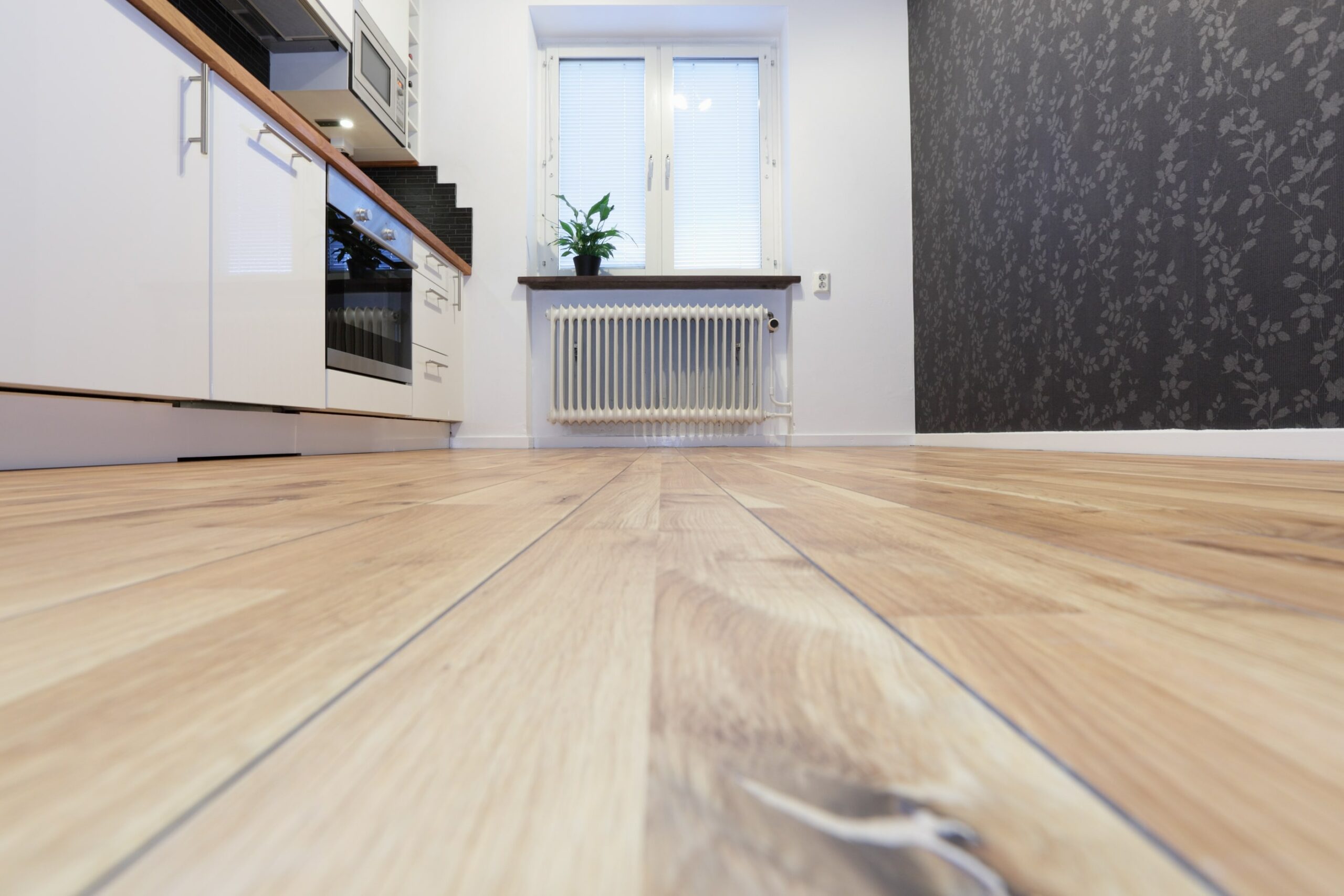 kitchen with white cabinets, wood countertop and wood floors