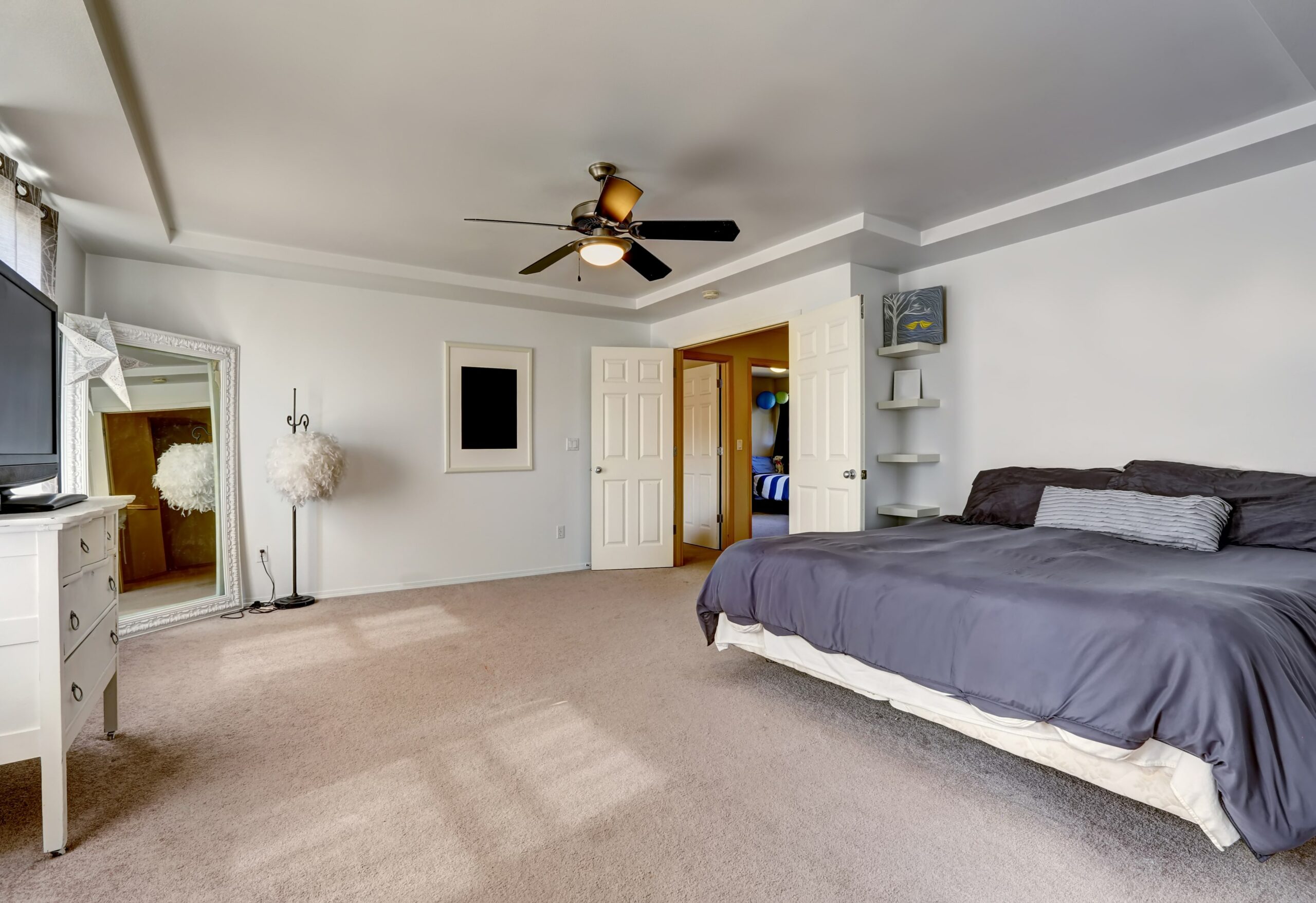Bedroom with carpet and bed with blue bedding