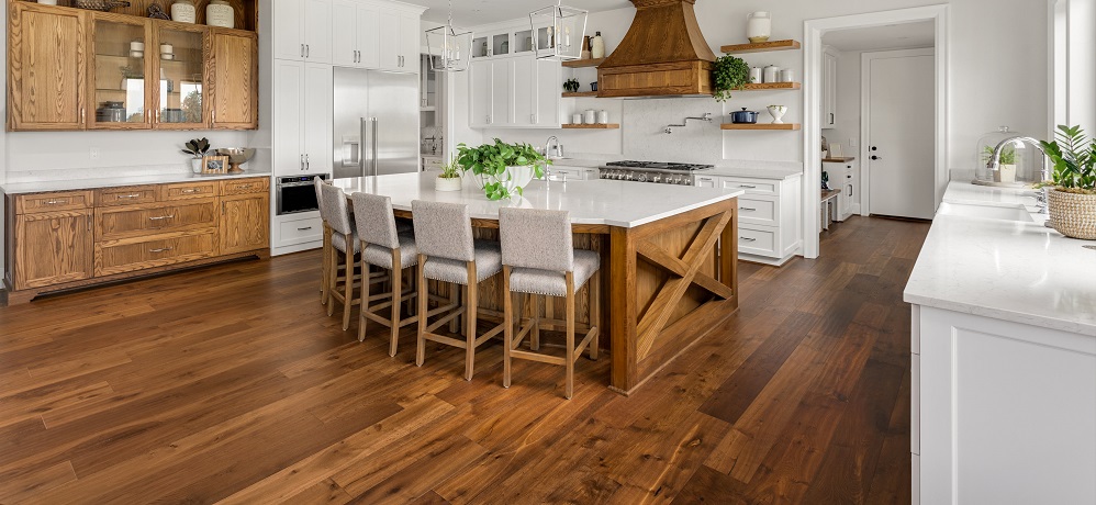 Hardwood flooring in kitchen with white cabinets