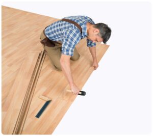 man installing flooring