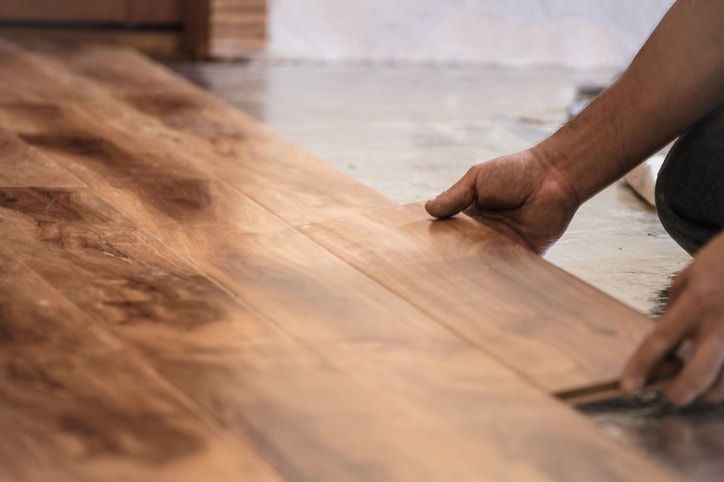 hand installing flooring planks