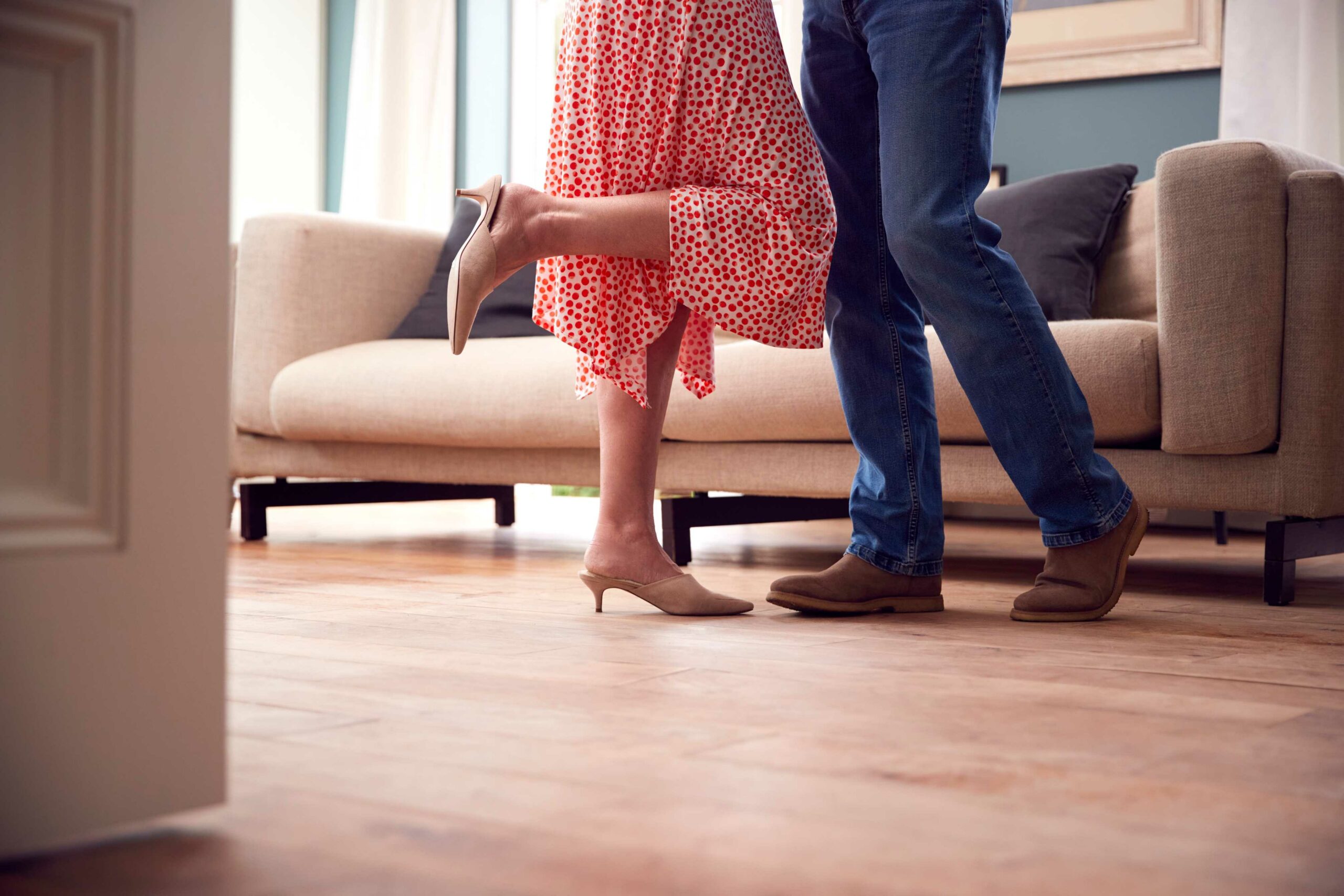 couple dancing inside house with laminate flooring