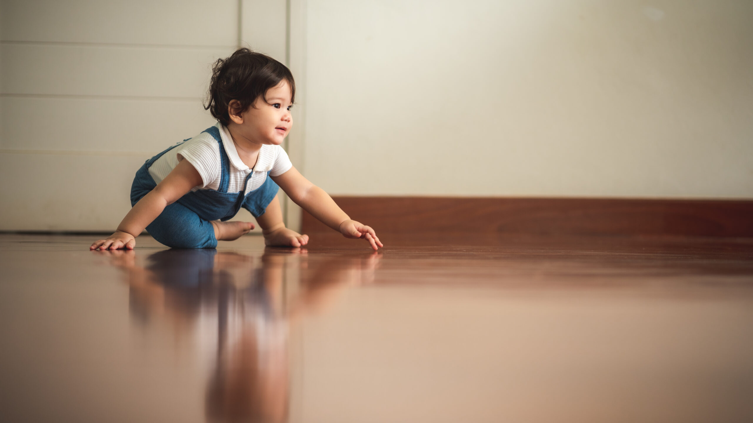 little baby boy crawling on the floor, cute child, beautiful son, holding father's hand and walking. smiling infant, family happy time concept. lovely and cute.