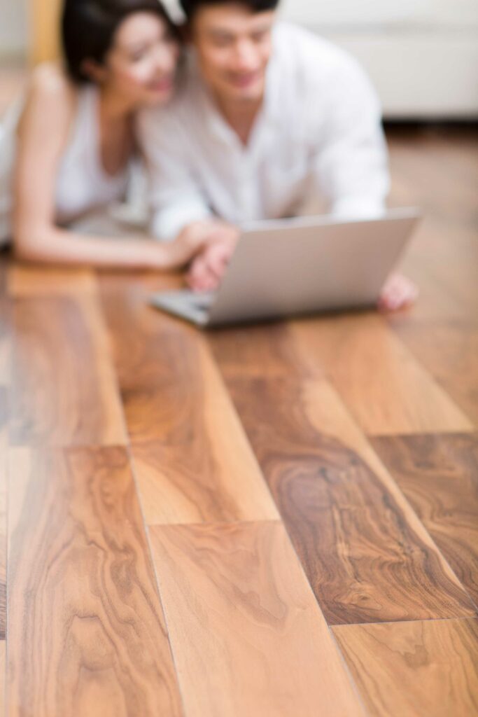 couple lying on luxury vinyl plank floor