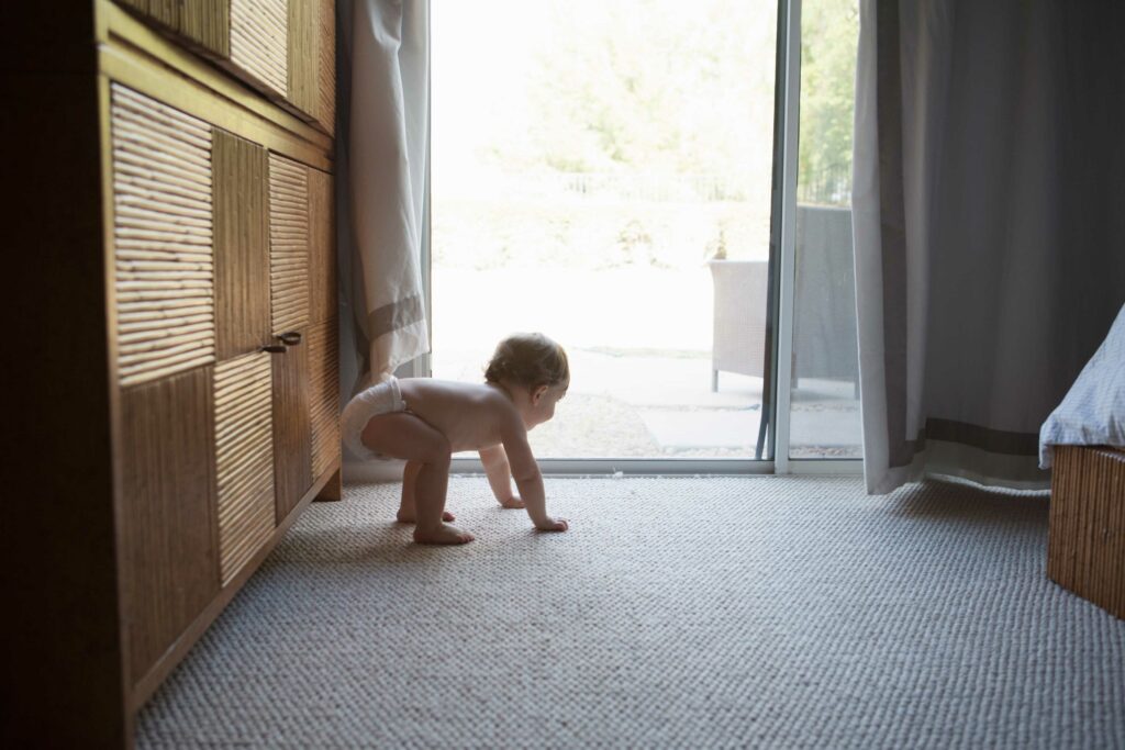 baby crawling on carpet