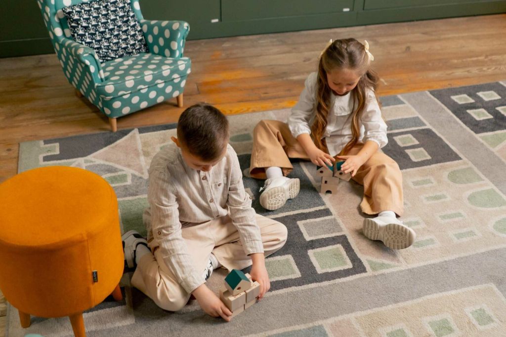two kids playing on carpet