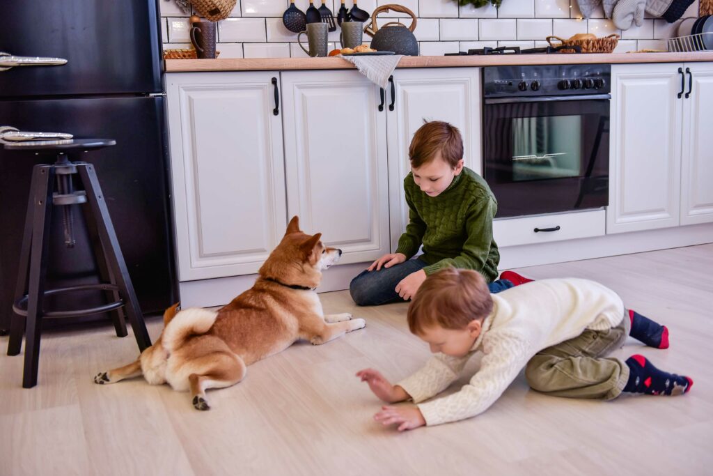 two boys playing with dog