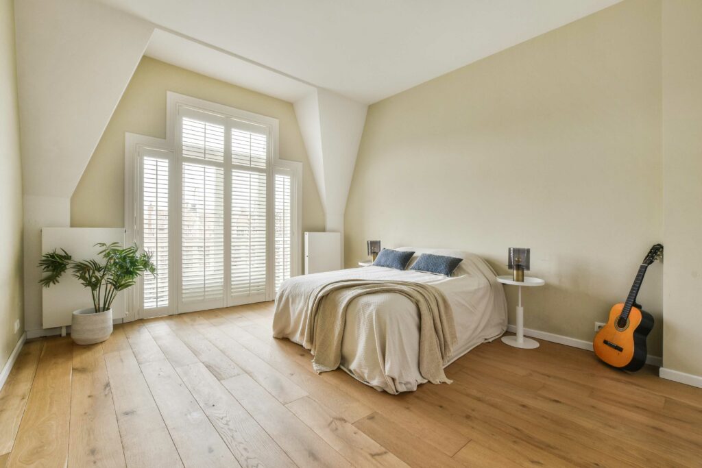 bedroom with guitar and engineered hardwood floor