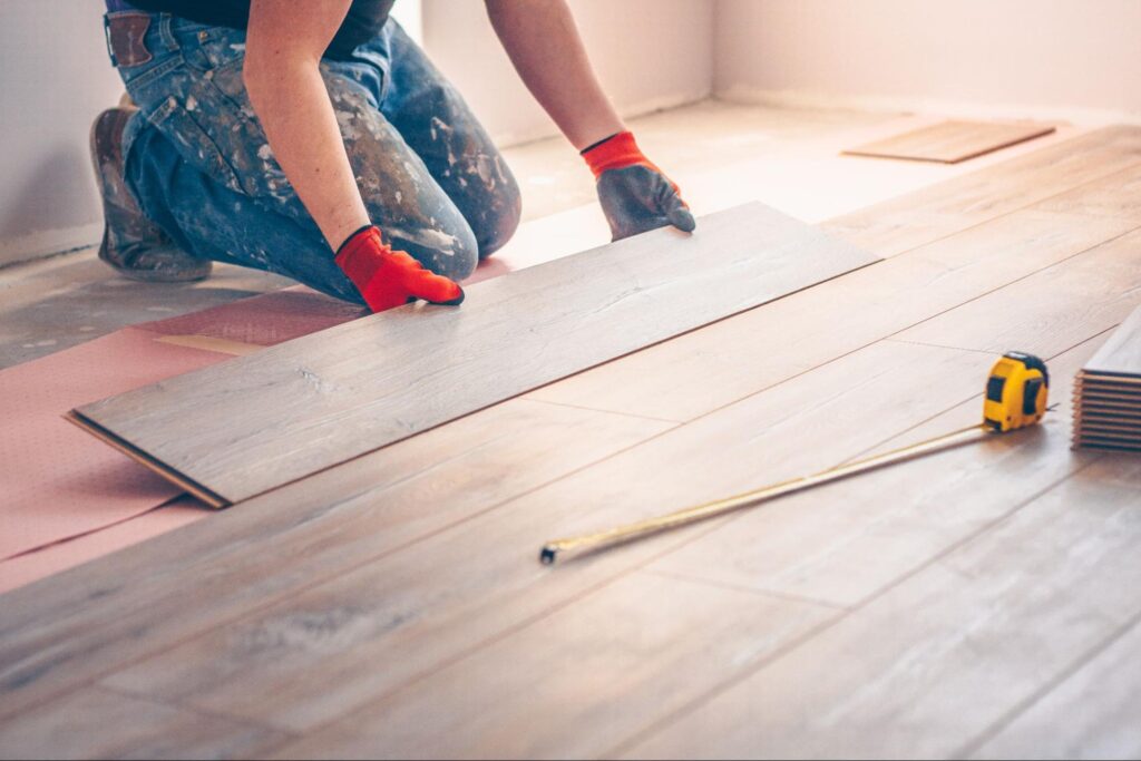 worker-professionally-installs-floor-boards