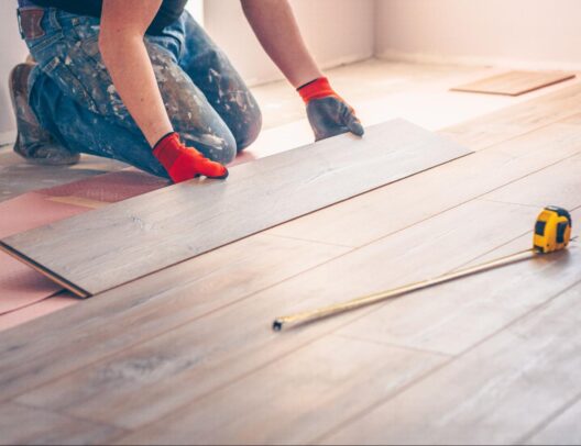 worker-professionally-installs-floor-boards